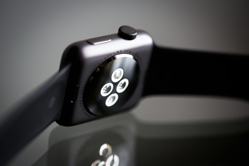Detailed image of the back sensor of a modern smartwatch showing reflective surface and technology focus.
